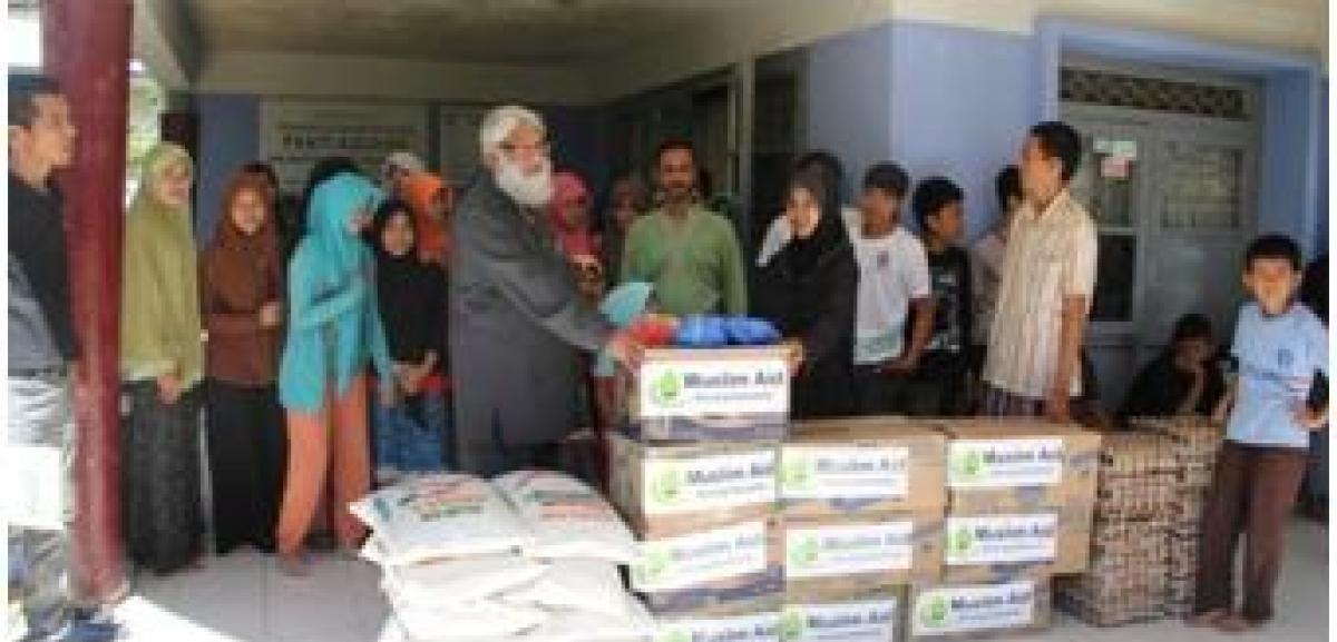 Vice Chairman of Muslim Aid, Dr Suhaib Hasan gives the Ramadan Feed the Fasting packs in the Muslim Aid Indonesia Field Office